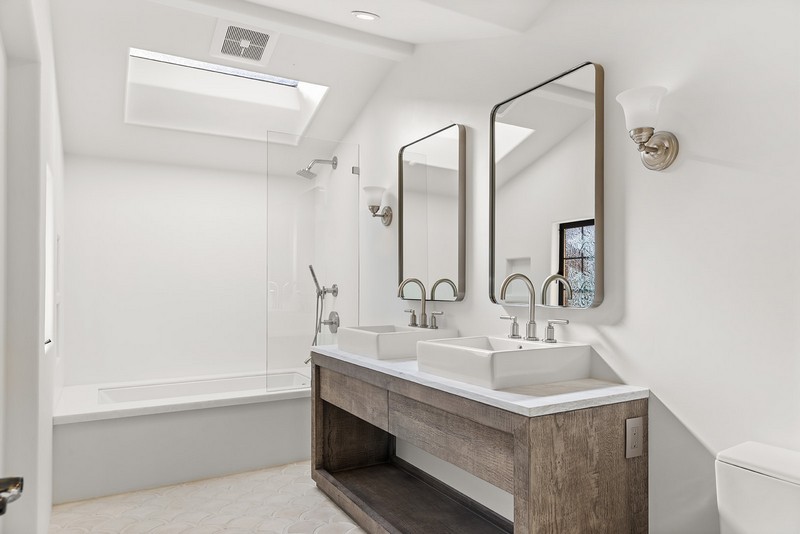 Bathroom remodel with double vanity — Carmel-by-the-Sea Remodeled bathroom with vessel sink, double mirrors, and skylight in Carmel-by-the-Sea