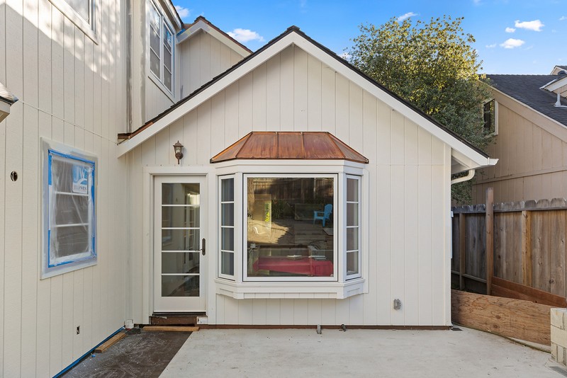 Cottage exterior remodel — Carmel-by-the-Sea Remodeled cottage exterior with bay window and copper roof accent in Carmel-by-the-Sea