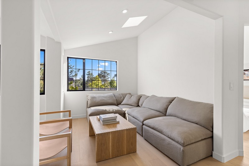 Family room remodel — Carmel-by-the-Sea Bright remodeled family room with grid-pattern windows and white walls in Carmel-by-the-Sea