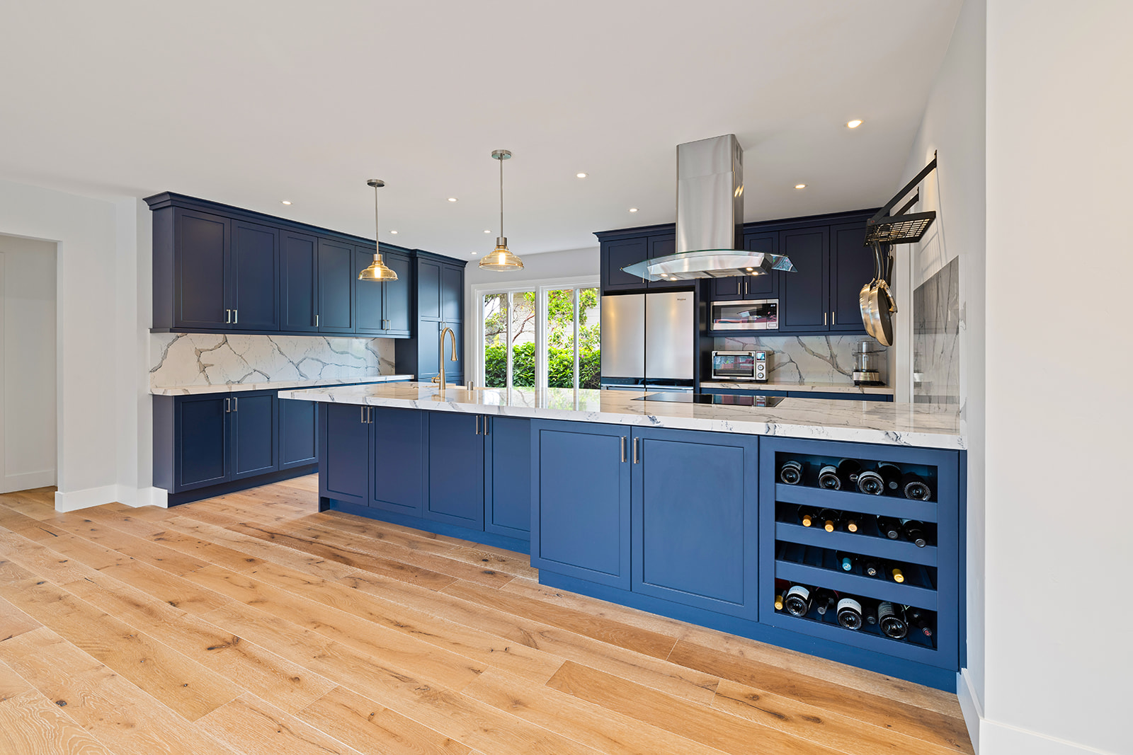Kitchen remodel with navy blue cabinets and quartz countertops by RC Builders Inc