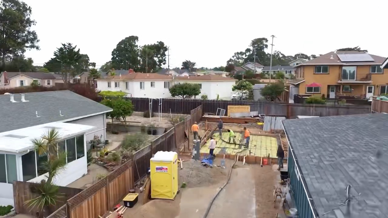 Job site aerial — Seaside Aerial view of an RC Builders concrete and foundation job site in a Monterey Peninsula neighborhood