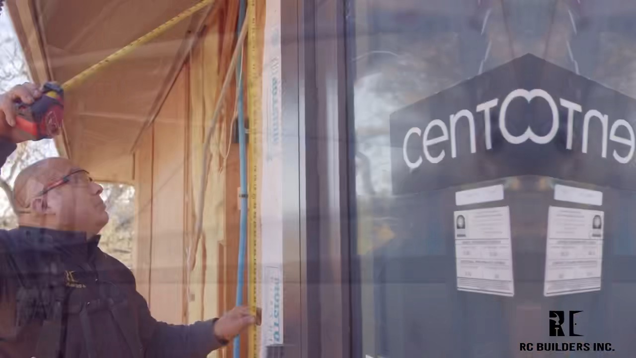 RC Builders carpenter measuring a window opening during installation